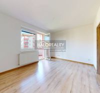 Studio apartment with wood-patterned flooring and a balcony, bright space.