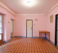 A room in a family house with pink walls and tiles.