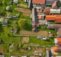 An aerial view of family houses in Horná Súča surrounded by greenery and gardens.