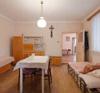 A dining room in a family house with furniture and flooring featuring a wooden decor.