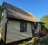 A family house with a sloped roof and a small terrace in Chotín on Pri stanici.