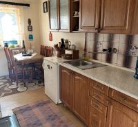 A kitchen in the Gardens with wooden decor and a dining nook.