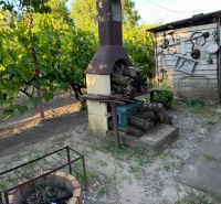 Gardens on Pri stanici Street in Chotín with an outdoor fireplace and vineyard.