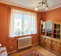 Living room in a 4-room apartment with a wooden decor floor and a wooden display cabinet.