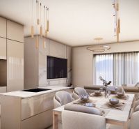 Dining area with a large table and hanging lights in a 4-room apartment.