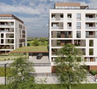 Apartment buildings on Suchoňova Street in Poprad with a green roof and parking.