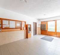 The entrance hall of an apartment building with a bulletin board and mailboxes on Južná trieda.