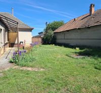 A family house in Tvrdošovce with a garden, flowers, and an outdoor terrace.