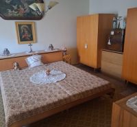 A bedroom in a family house with historical furniture and decorations of a religious nature.