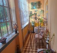 A cozy corner in a family house with curtains and a view of the garden.