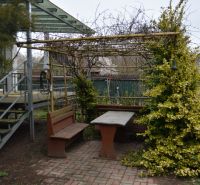 A gazebo with wooden benches and a table behind a family house in Borský Svätý Jur, Húšky.