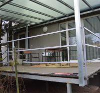 A terrace with a covered structure, simple railing, and seating at a family house on Húšky in Borský Svätý Jur.