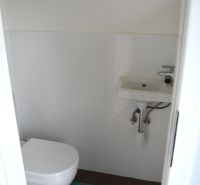 Bathroom with toilet and sink in a family house.