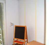 Children's corner with a blackboard in a family house, floor with wooden decor.