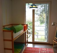 A children's room in a family house with a bunk bed and a carpet with numbers.