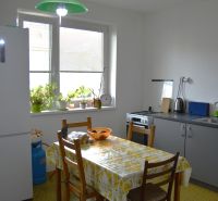 A kitchen in a family house with a dining table and houseplants on the windowsill.