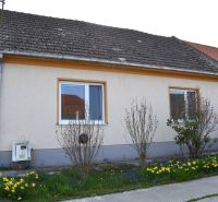A family house in Nižná with a flower garden and a shingle roof.