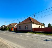 A family house in Orechová Potôň, light facade, red roof, by the road.