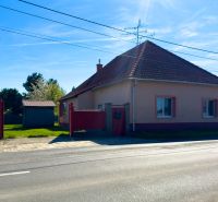 A family house in Orechová Potôň with a sloped roof and a fenced plot.