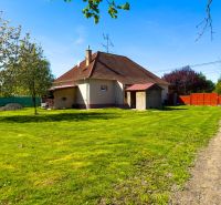 A family house in Orechová Potôň with a large garden, surrounded by greenery and trees.