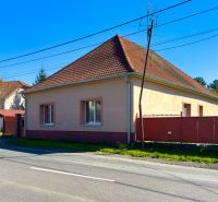 A family house in Orechová Potôň with a classic sloped roof and a red fence.