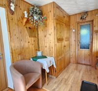 The interior of a family house with a wooden decor floor and wooden walls.