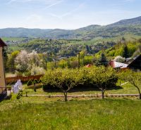 A family house in Štiavnické Bane with a garden and panoramic views of the green hills.