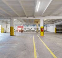 A spacious hall with yellow safety pillars and parking spaces in warehouses and halls.