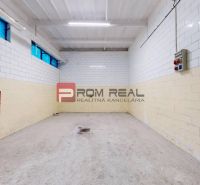 A space with white tiled walls and lighting, suitable for warehouses and halls.