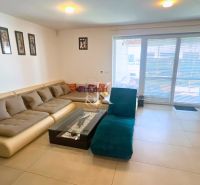 Living room in a family house with a comfortable couch and large glass doors.