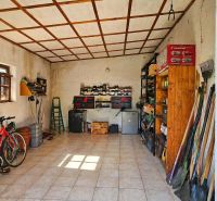 A storage room in a family house with bicycles, tools, and shelves.