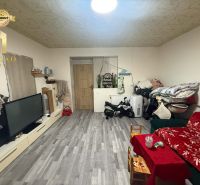 Living room in a family house with a wooden decor floor and a television.