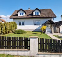 A family house in Spišský Štvrtok with a garage, garden, and landscaped exterior.