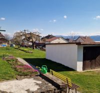 A garden at a family house in Spišský Štvrtok with a gazebo and flower beds.