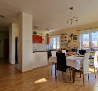 Dining area in a family house with a wooden patterned floor and decorative elements.