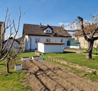 A family house in Spišský Štvrtok with a landscaped garden and young trees.