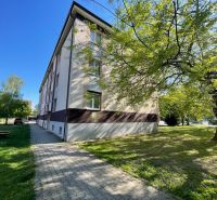 The exterior of the apartment building on Zornička Street in Galanta, surrounding greenery and sidewalk.