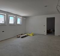 A spacious room in a 3-room apartment with white walls and light tiles.