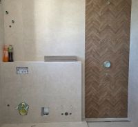 Bathroom in a 3-room apartment with wood decor tiles and prepared installation.