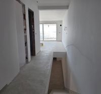 Hallway in a 3-room apartment with a staircase and a view of the balcony door.