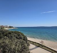 View of the coast with a beach in Mandre, beautiful blue ocean and clear sky.