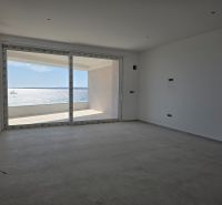 A spacious interior of a 3-room apartment with a sea view and large windows.