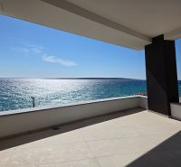 A terrace with a sea view in a 3-room apartment in Mandre, sunny weather, clear sky.