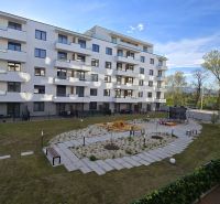 An apartment building in Zvolen with a playground and greenery near modern 3-room apartments.