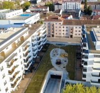 A view of a residential complex with parking and greenery in the city of Zvolen.