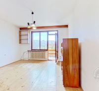 A bright room in a family house with a wooden decor floor, simple furniture.