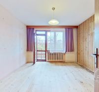 A room in a family house with a floor featuring a wooden decor and balcony doors.