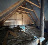 The attic of a family house with a wooden structure and various materials in Vislanka.
