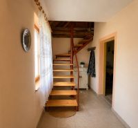 Interior of a family house with a staircase, tiles, and decorative accessories.