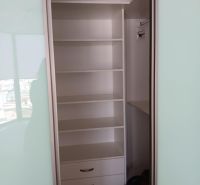 Built-in wardrobe with shelves and drawers in a 2-room apartment.
